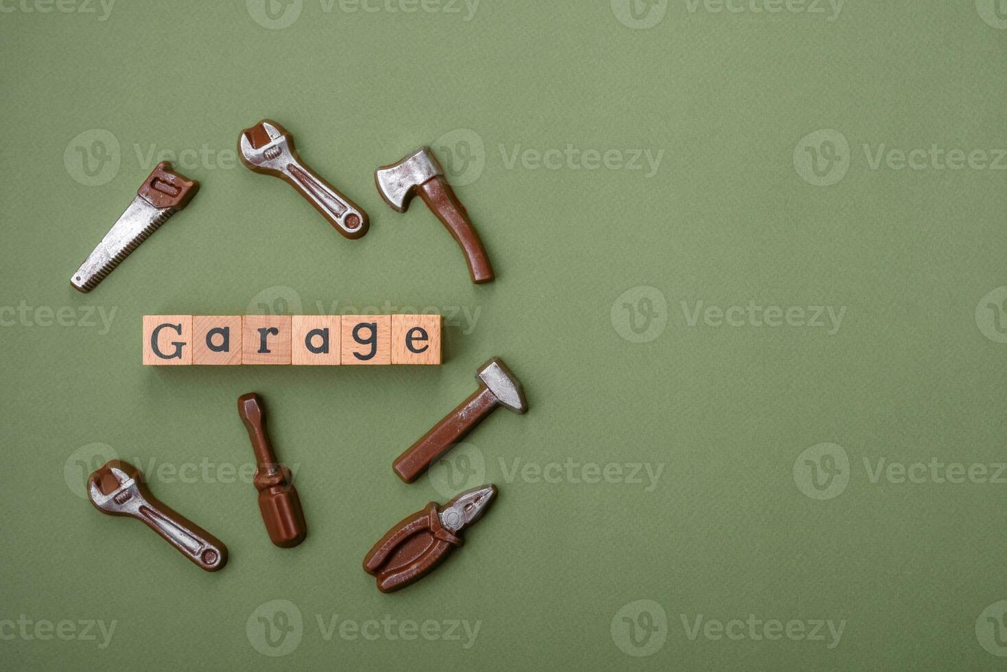 Tools and inscriptions symbolizing repairs or a garage and its attributes on a plain background photo