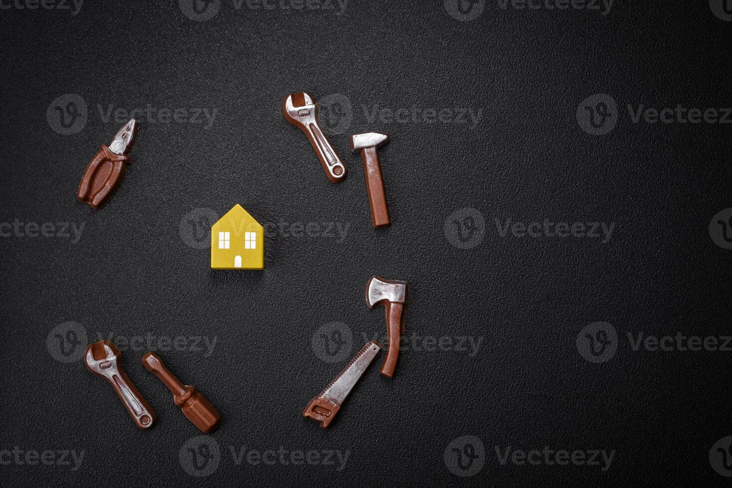 Repair or home improvement tools and a house model on a plain background photo