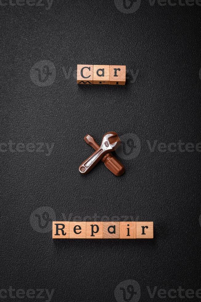 Tools and inscriptions symbolizing repairs or a garage and its attributes on a plain background photo