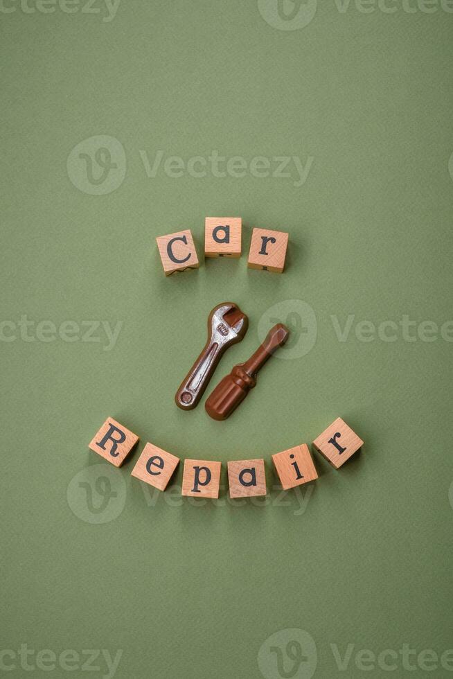 Tools and inscriptions symbolizing repairs or a garage and its attributes on a plain background photo