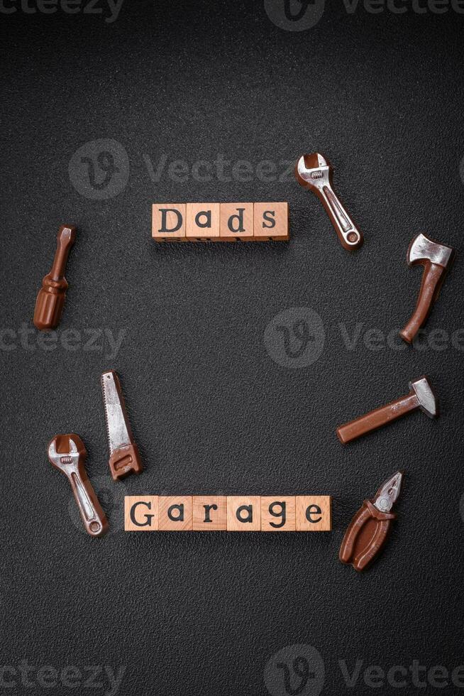 Tools and inscriptions symbolizing repairs or a garage and its attributes on a plain background photo