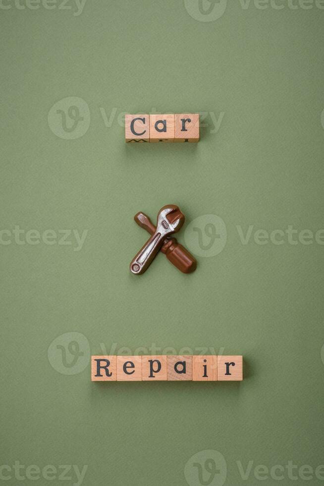 Tools and inscriptions symbolizing repairs or a garage and its attributes on a plain background photo