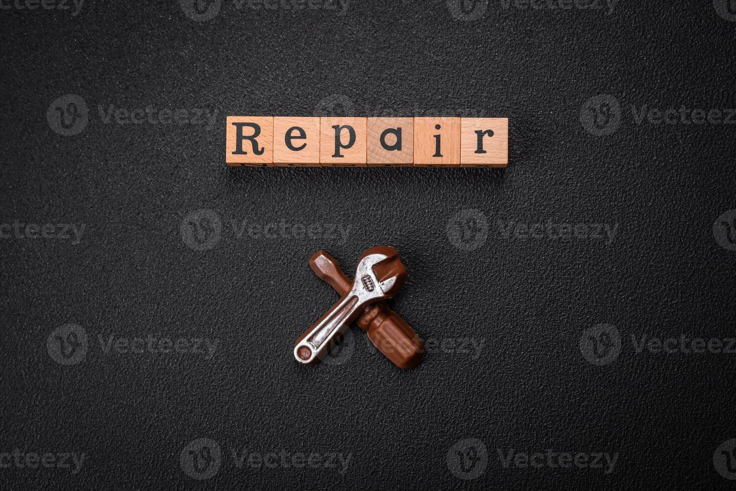 Tools and inscriptions symbolizing repairs or a garage and its attributes on a plain background photo
