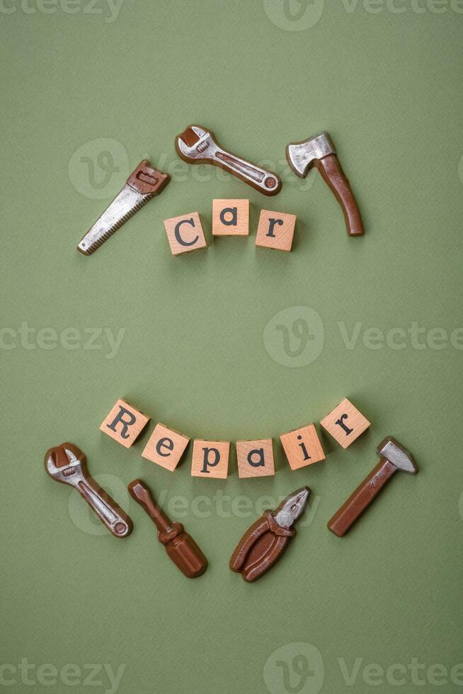 Tools and inscriptions symbolizing repairs or a garage and its attributes on a plain background photo