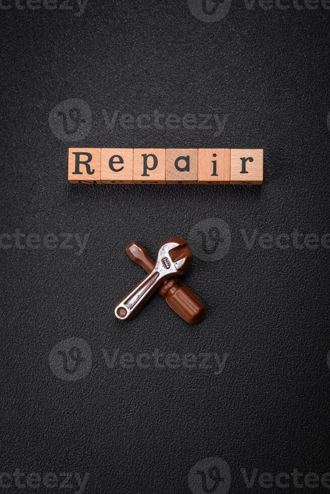 Tools and inscriptions symbolizing repairs or a garage and its attributes on a plain background photo