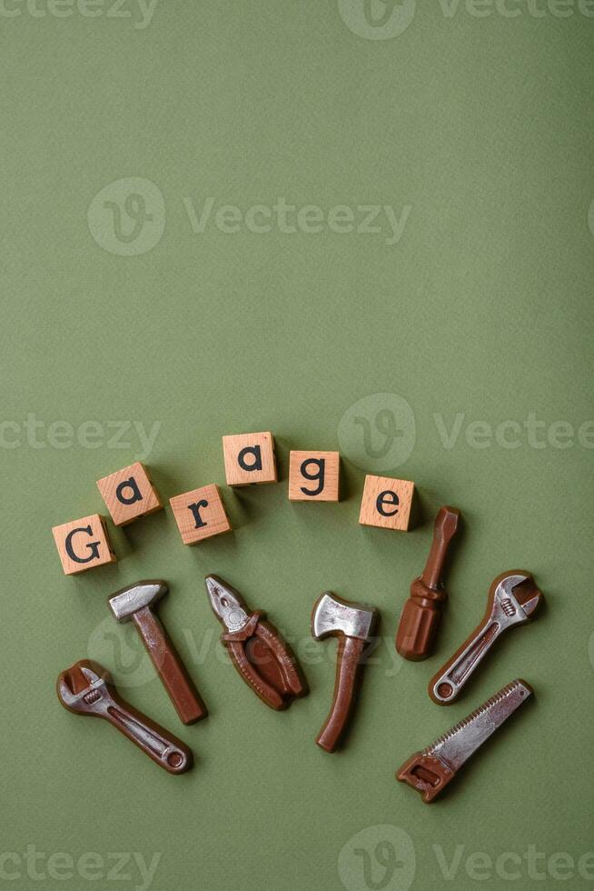 Tools and inscriptions symbolizing repairs or a garage and its attributes on a plain background photo