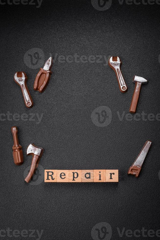 Tools and inscriptions symbolizing repairs or a garage and its attributes on a plain background photo