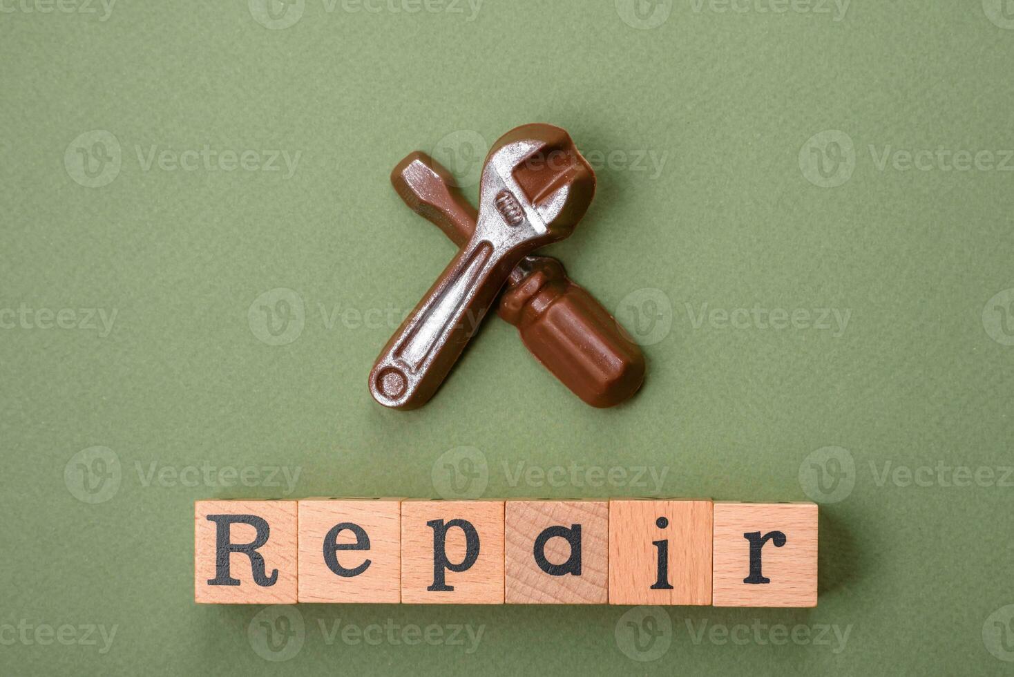 Tools and inscriptions symbolizing repairs or a garage and its attributes on a plain background photo