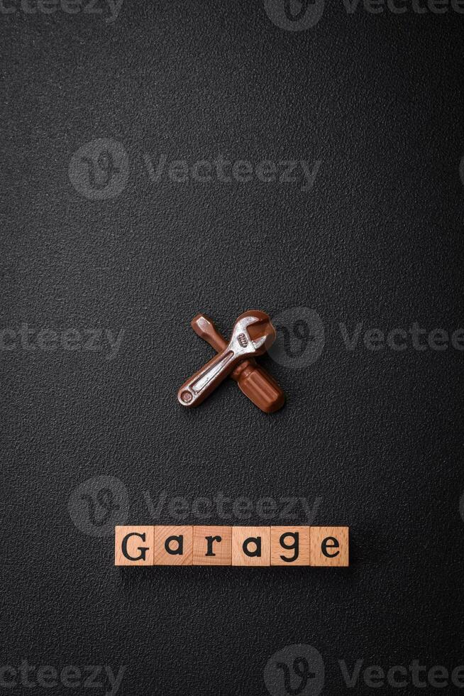 Tools and inscriptions symbolizing repairs or a garage and its attributes on a plain background photo