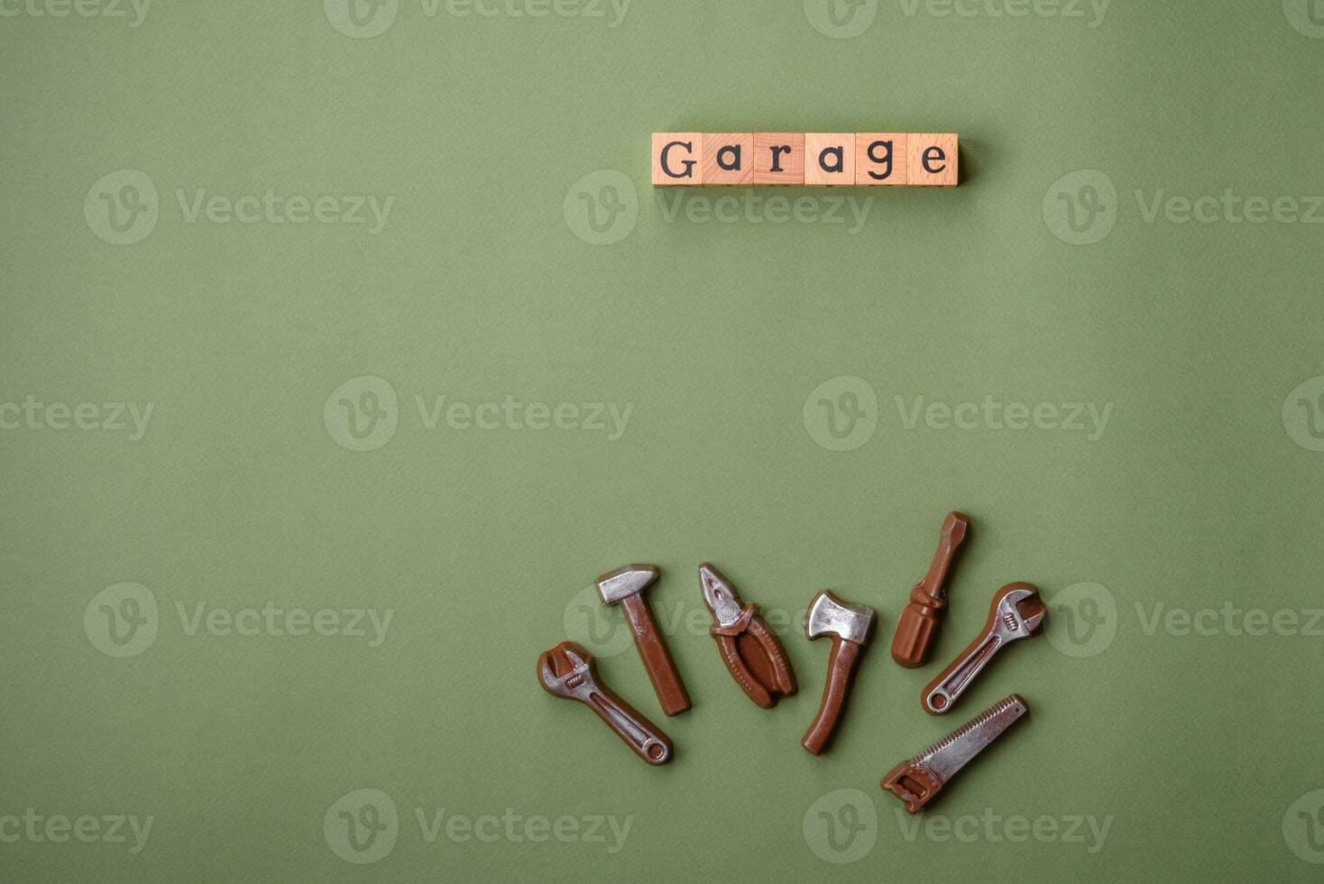 Tools and inscriptions symbolizing repairs or a garage and its attributes on a plain background photo