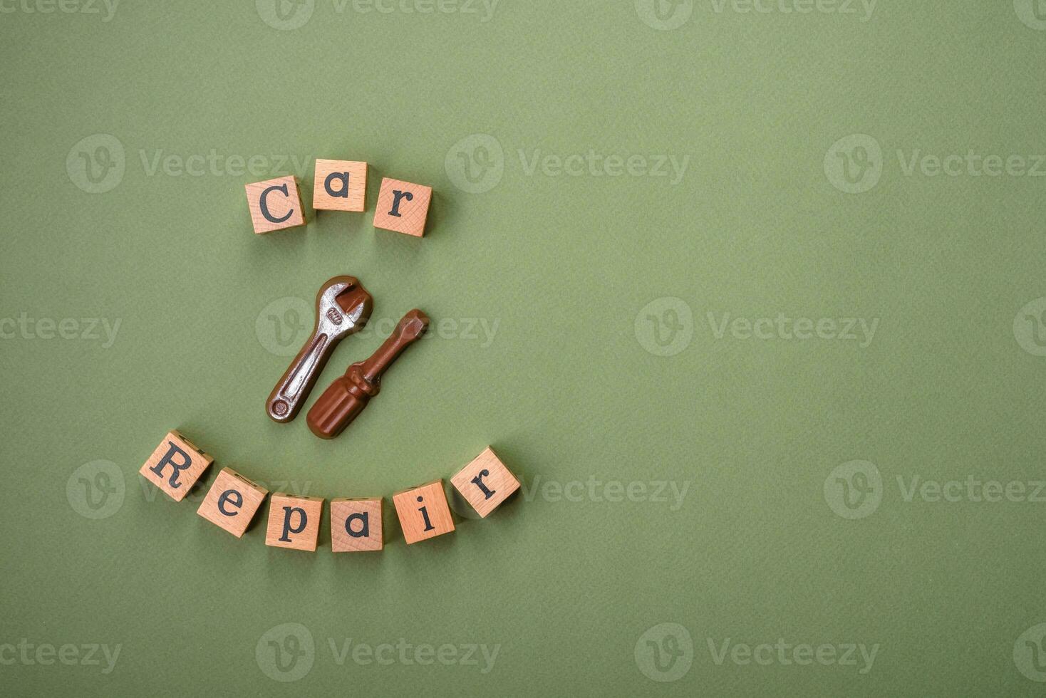 Tools and inscriptions symbolizing repairs or a garage and its attributes on a plain background photo