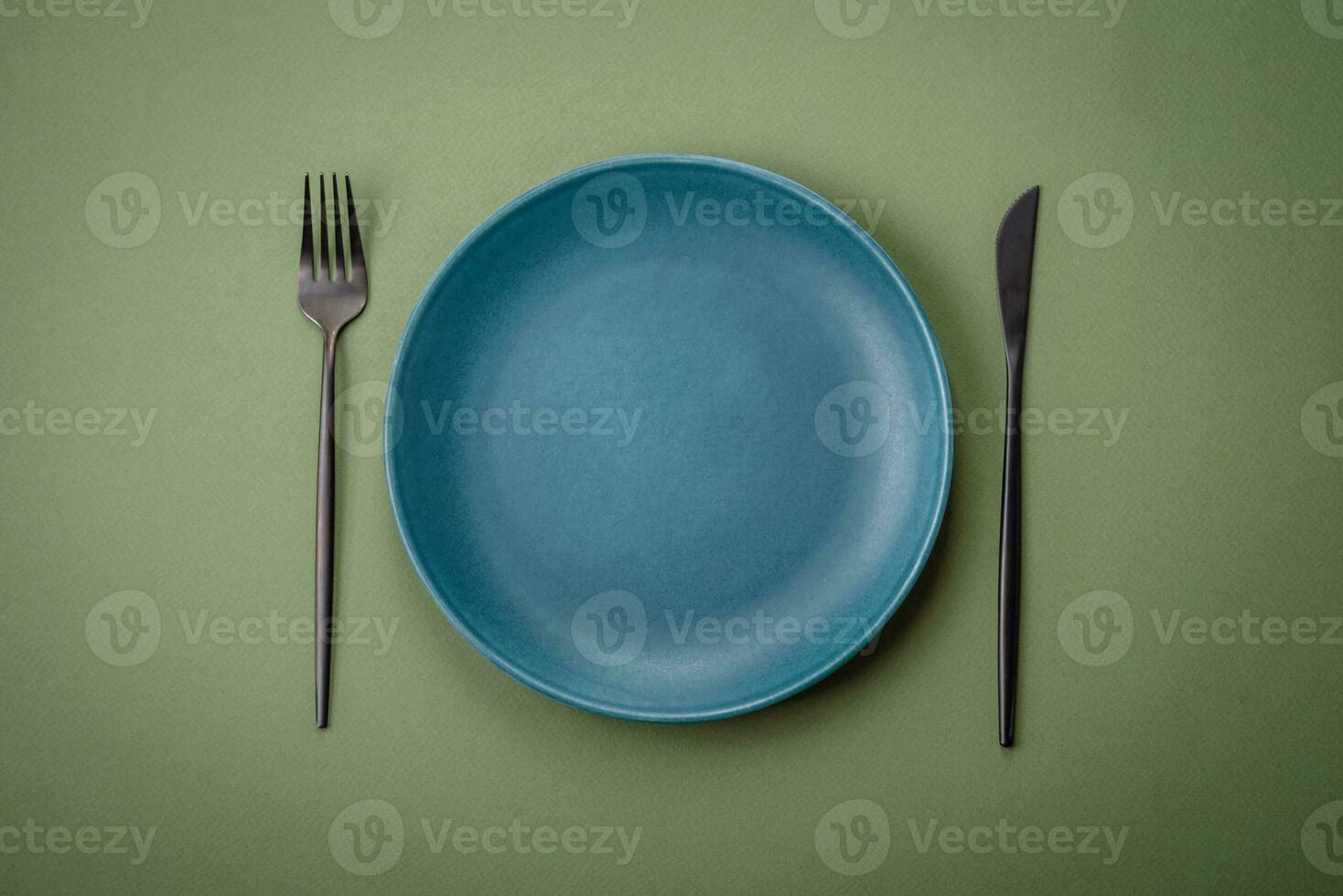 Empty round ceramic plate on a plain background, flatley with copy space photo