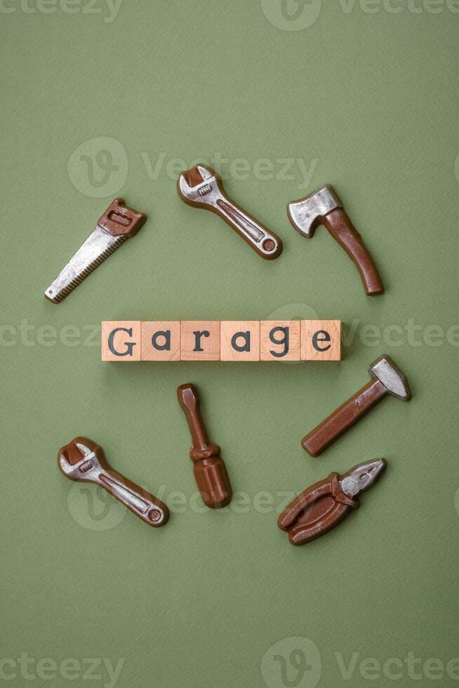 Tools and inscriptions symbolizing repairs or a garage and its attributes on a plain background photo