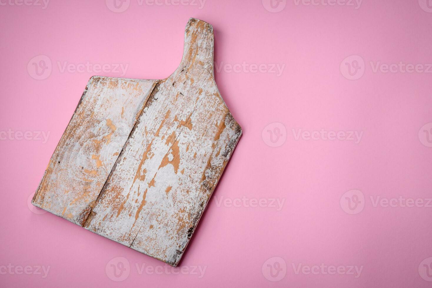 Empty wooden rectangular cutting board on a plain background, flatley with copy space photo