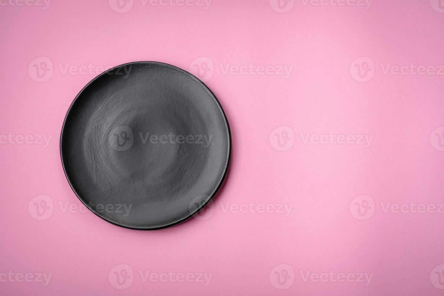 Empty round ceramic plate on a plain background, flatley with copy space photo