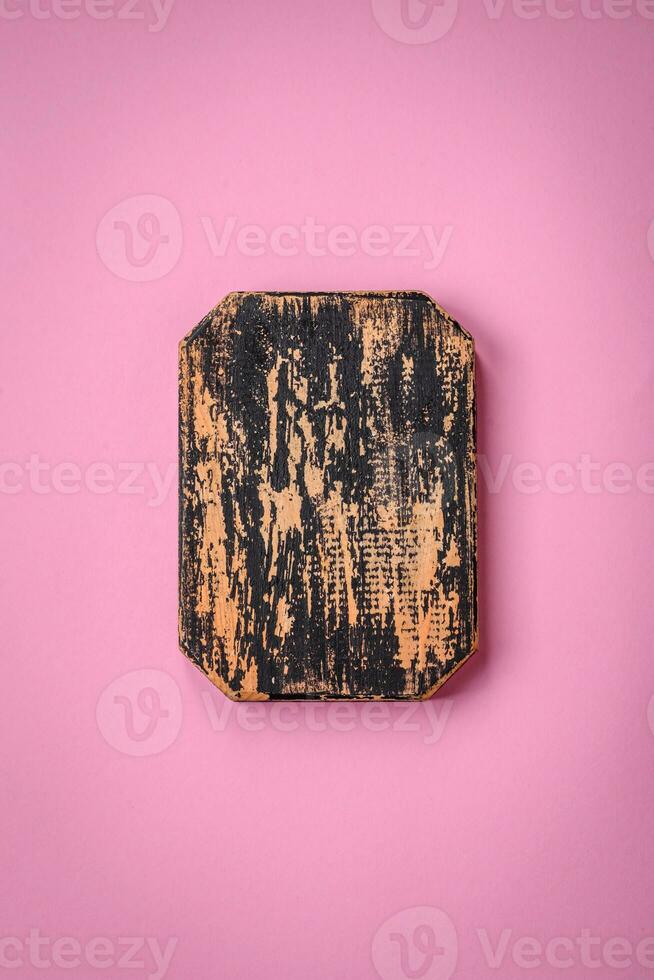 Empty wooden rectangular cutting board on a plain background, flatley with copy space photo