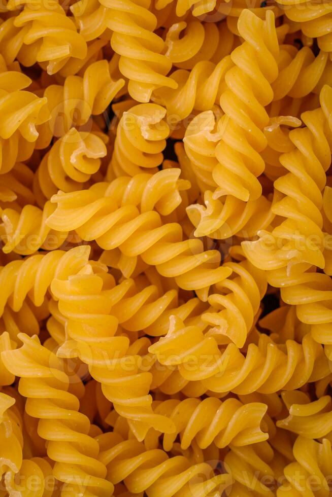 Raw fusilli pasta from whole grain wheat varieties photo