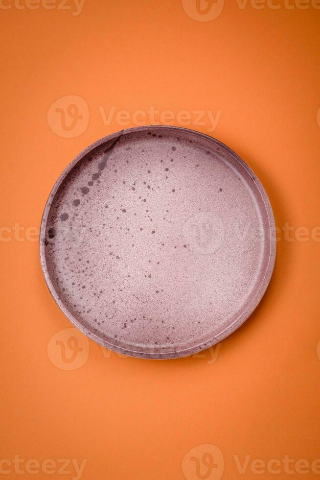 Empty round ceramic plate on a plain background, flatley with copy space photo