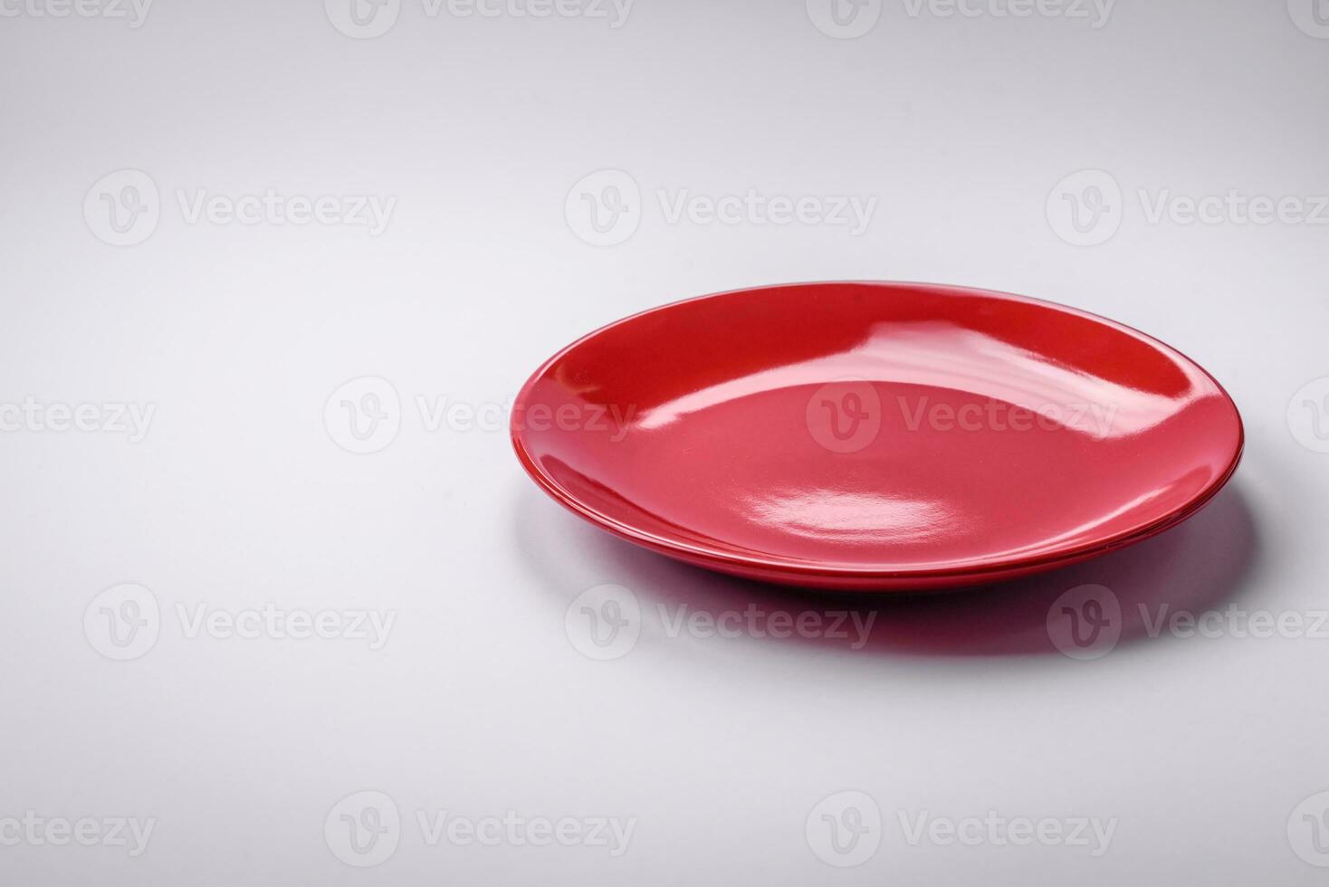 Empty round ceramic plate on a plain background, flatley with copy space photo