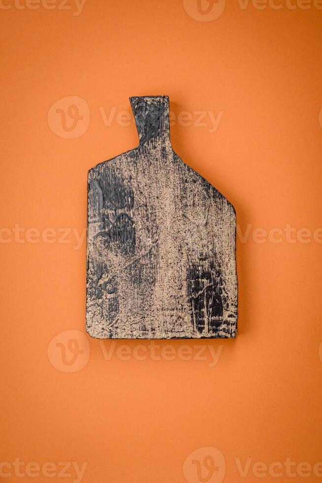 Empty wooden rectangular cutting board on a plain background, flatley with copy space photo