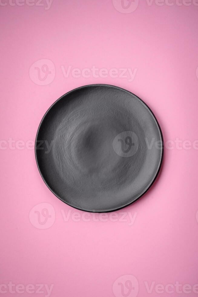 Empty round ceramic plate on a plain background, flatley with copy space photo