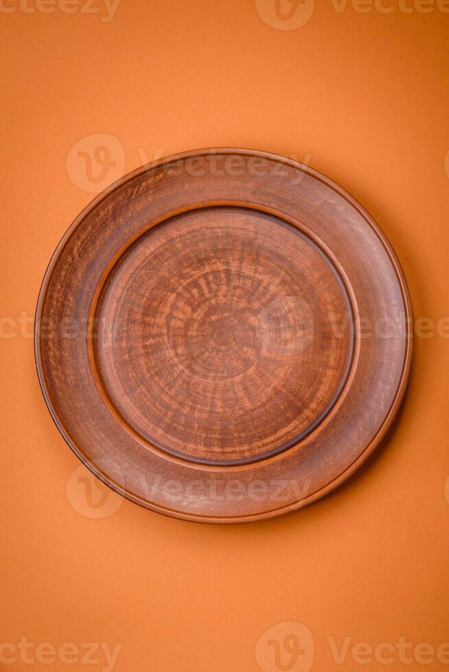 Empty round ceramic plate on a plain background, flatley with copy space photo