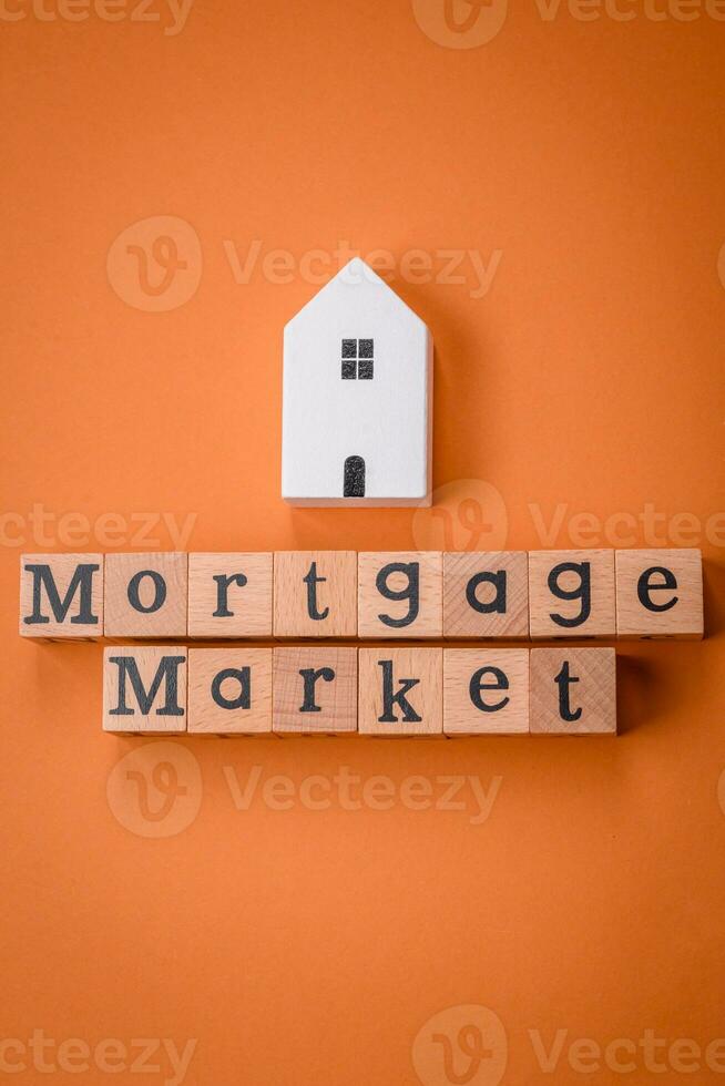 A small wooden house and keys as an idea for investing in your own home photo