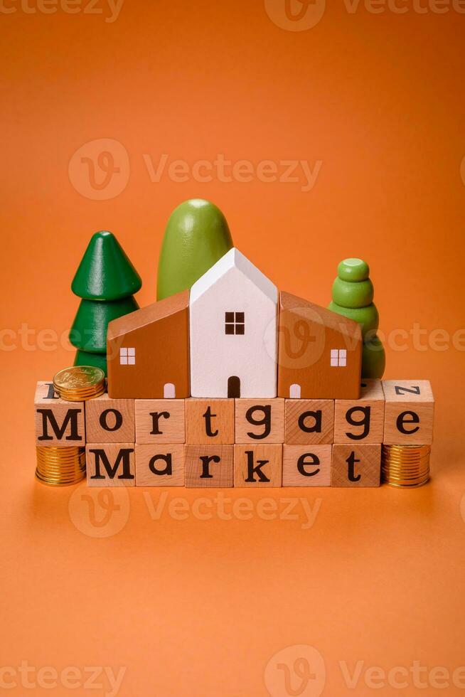 A small wooden house and keys as an idea for investing in your own home photo