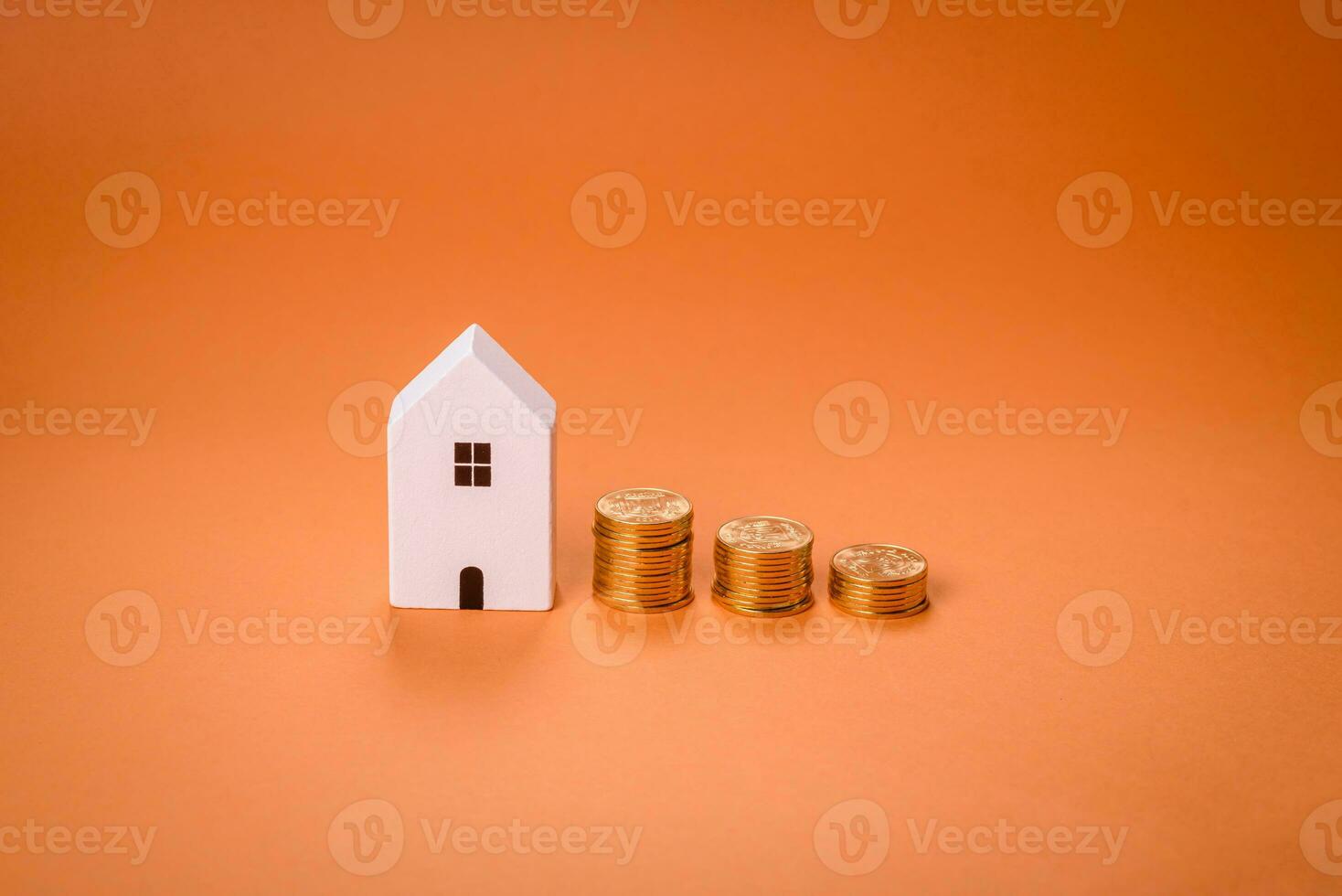 A small wooden house and keys as an idea for investing in your own home photo