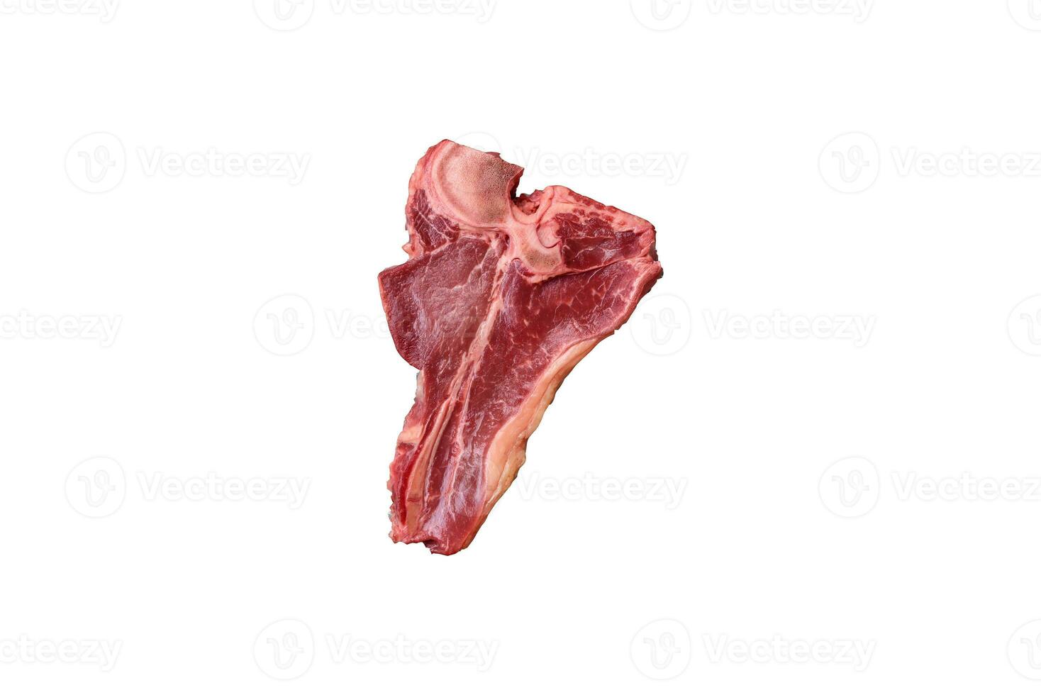 Raw fresh juicy beef t-bone steak with salt, spices and herbs photo