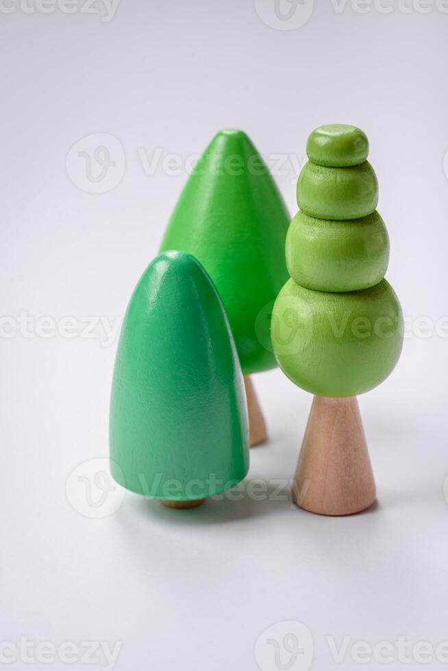 Wooden model of a tree with a green crown and trunk on a white background photo