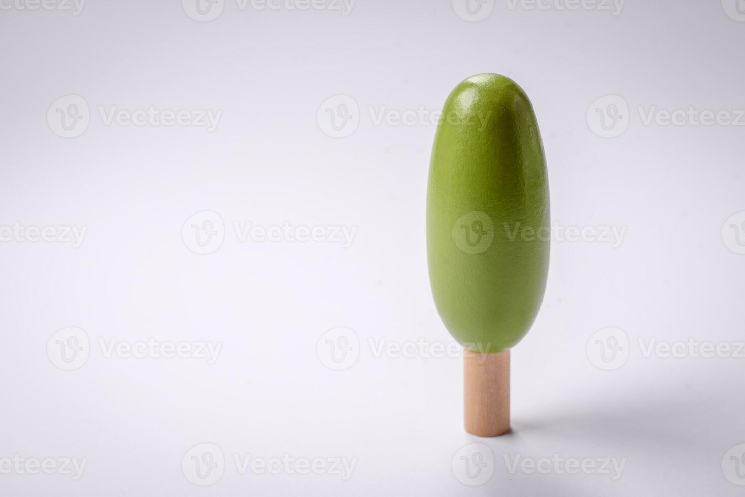 Wooden model of a tree with a green crown and trunk on a white background photo