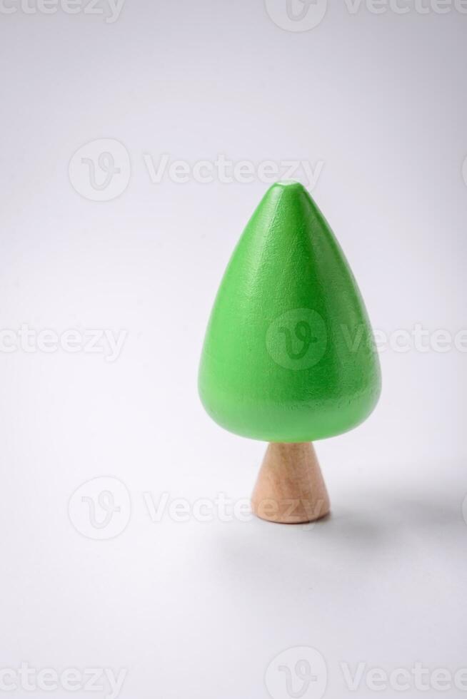 Wooden model of a tree with a green crown and trunk on a white background photo