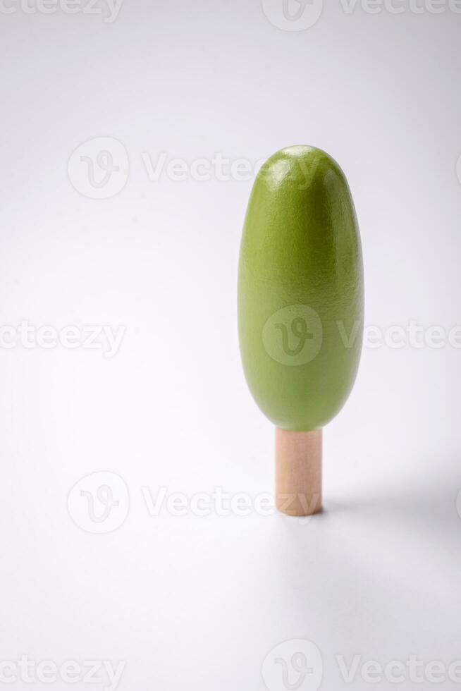 Wooden model of a tree with a green crown and trunk on a white background photo