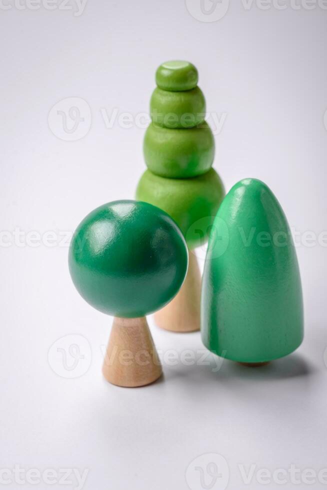 Wooden model of a tree with a green crown and trunk on a white background photo