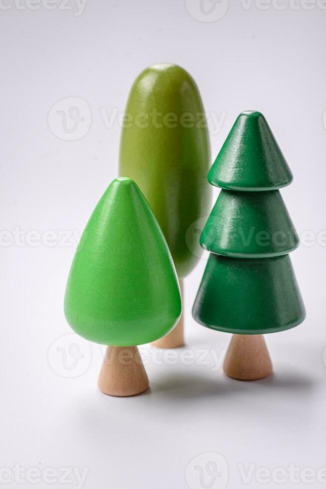 Wooden model of a tree with a green crown and trunk on a white background photo