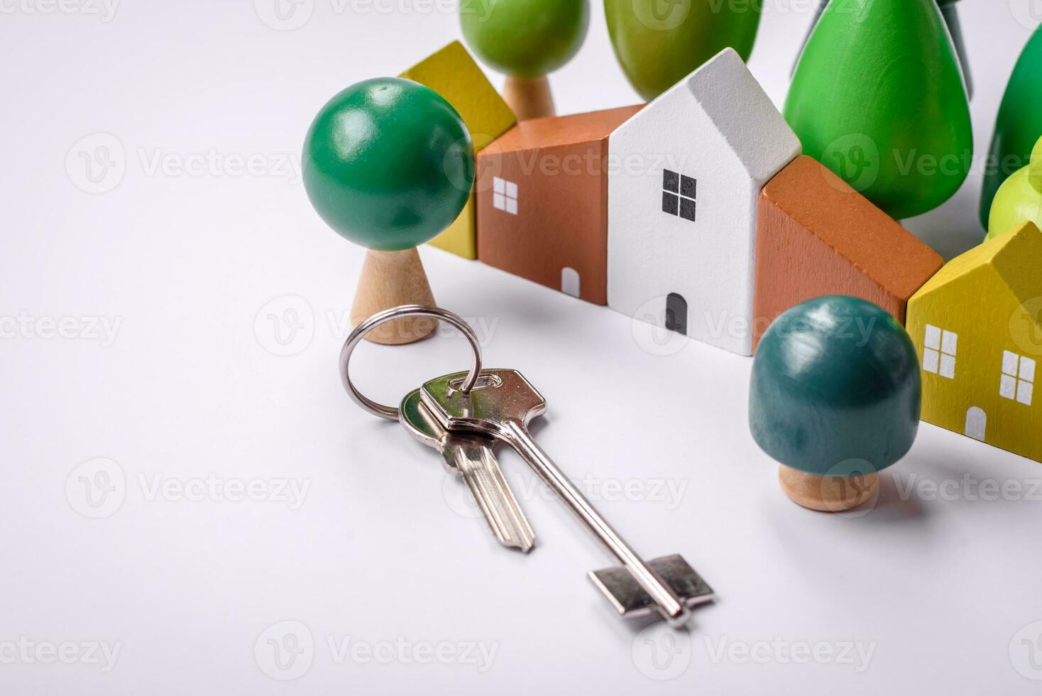 A small wooden house and keys as an idea for investing in your own home photo