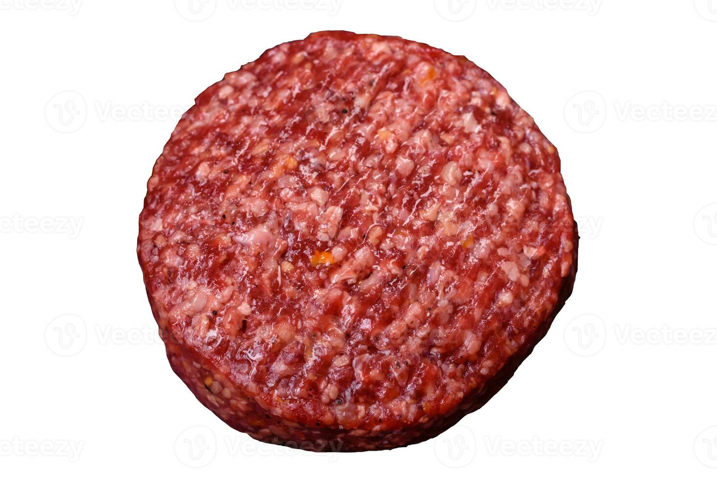 Fresh raw ground beef burger patty with salt and spices photo