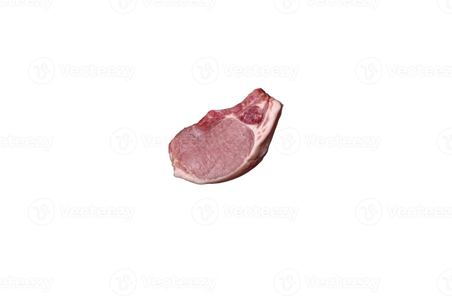 Raw pork on the bone or rib sliced with salt, spices and herbs photo