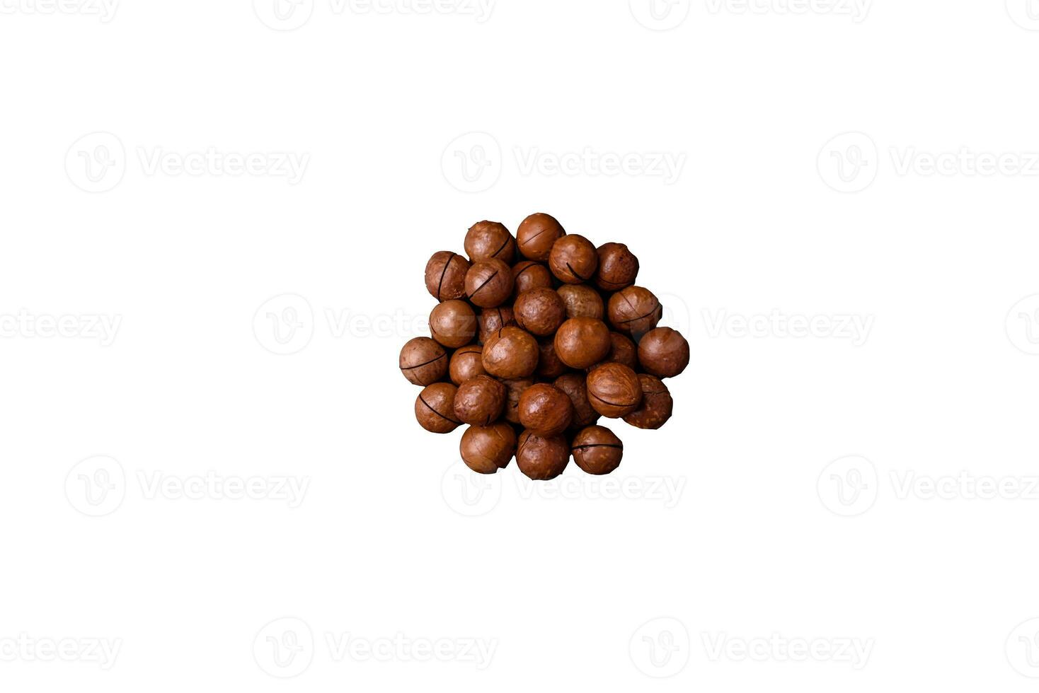 Delicious roasted macadamia nuts in shell on a dark textured background photo