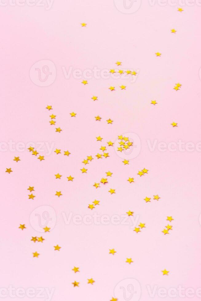 Sparkle stars shape on a pink background. Happy new year background photo