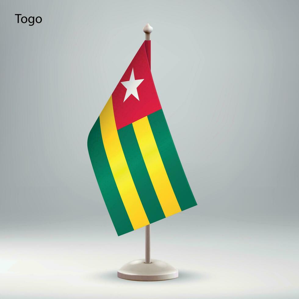 Flag of Togo hanging on a flag stand. vector