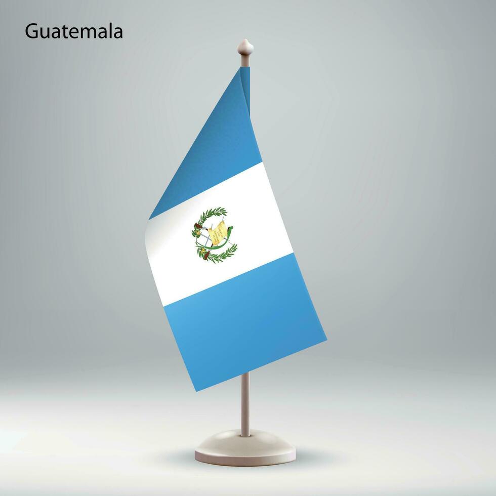 Flag of Guatemala hanging on a flag stand. vector
