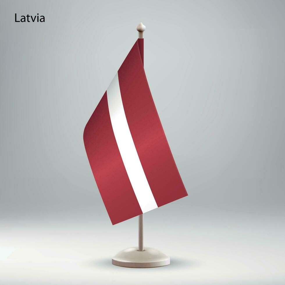 Flag of Latvia hanging on a flag stand. vector