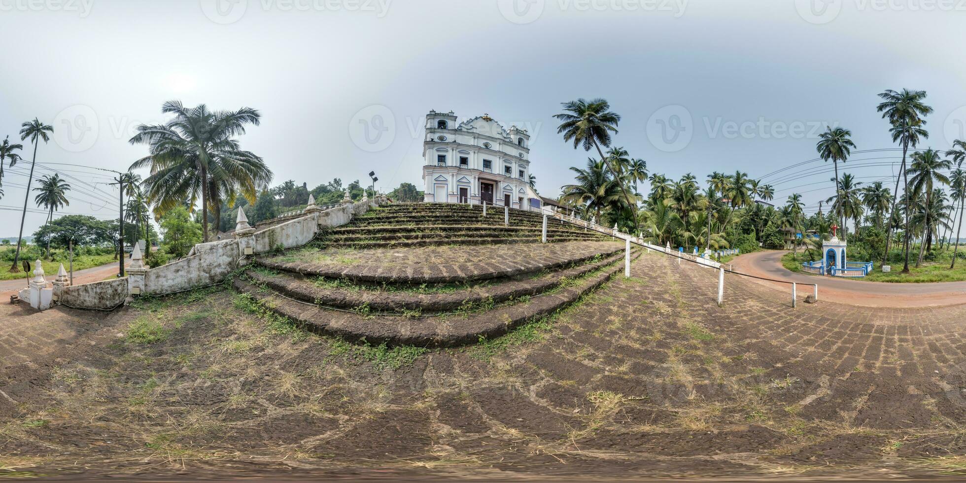 hdri 360 panorama of portuguese catholic church in jungle among palm trees in Indian tropic village in equirectangular projection. VR AR content photo