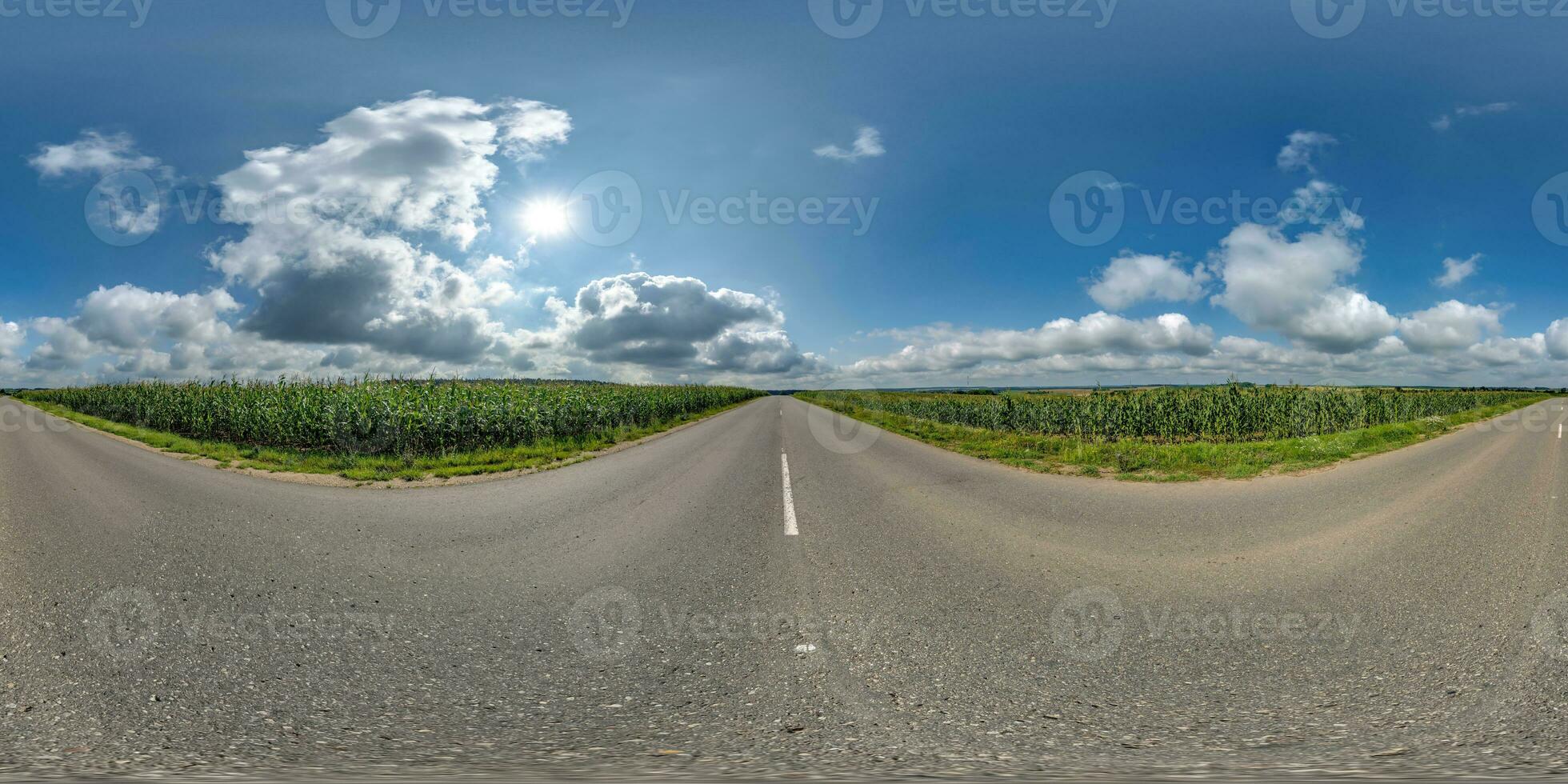 spherical 360 hdri panorama on old asphalt road among corn fields with clouds and sun on blue sky in equirectangular seamless projection, as skydome replacement in drone panoramas, game development photo