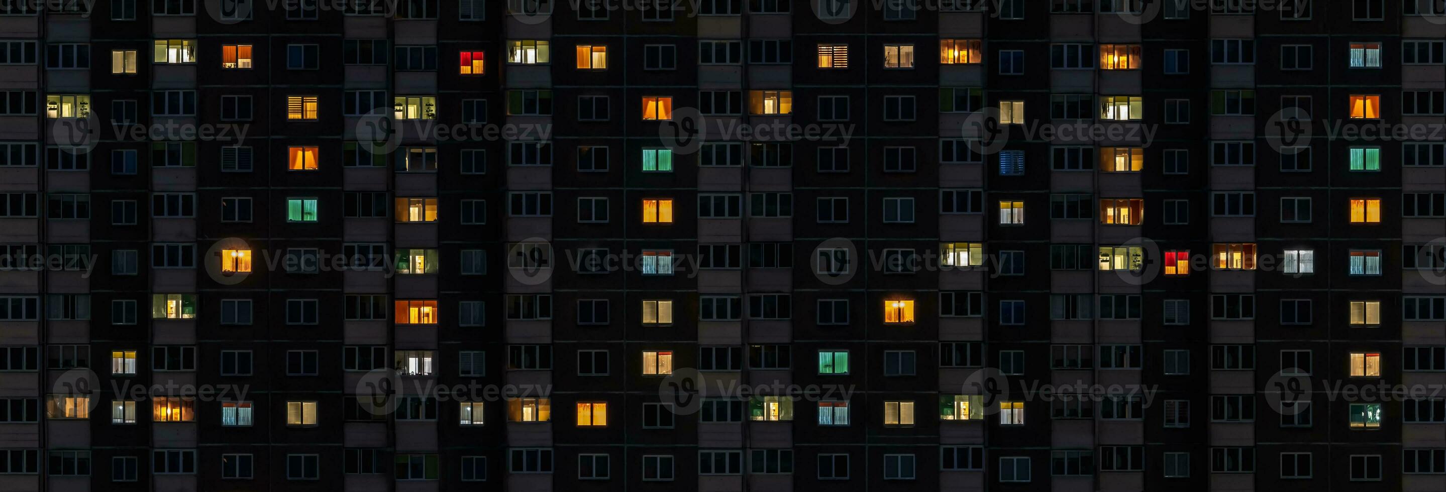 flat night panorama of multicolor light in windows of multistory buildings as concept for 2024 new year photo