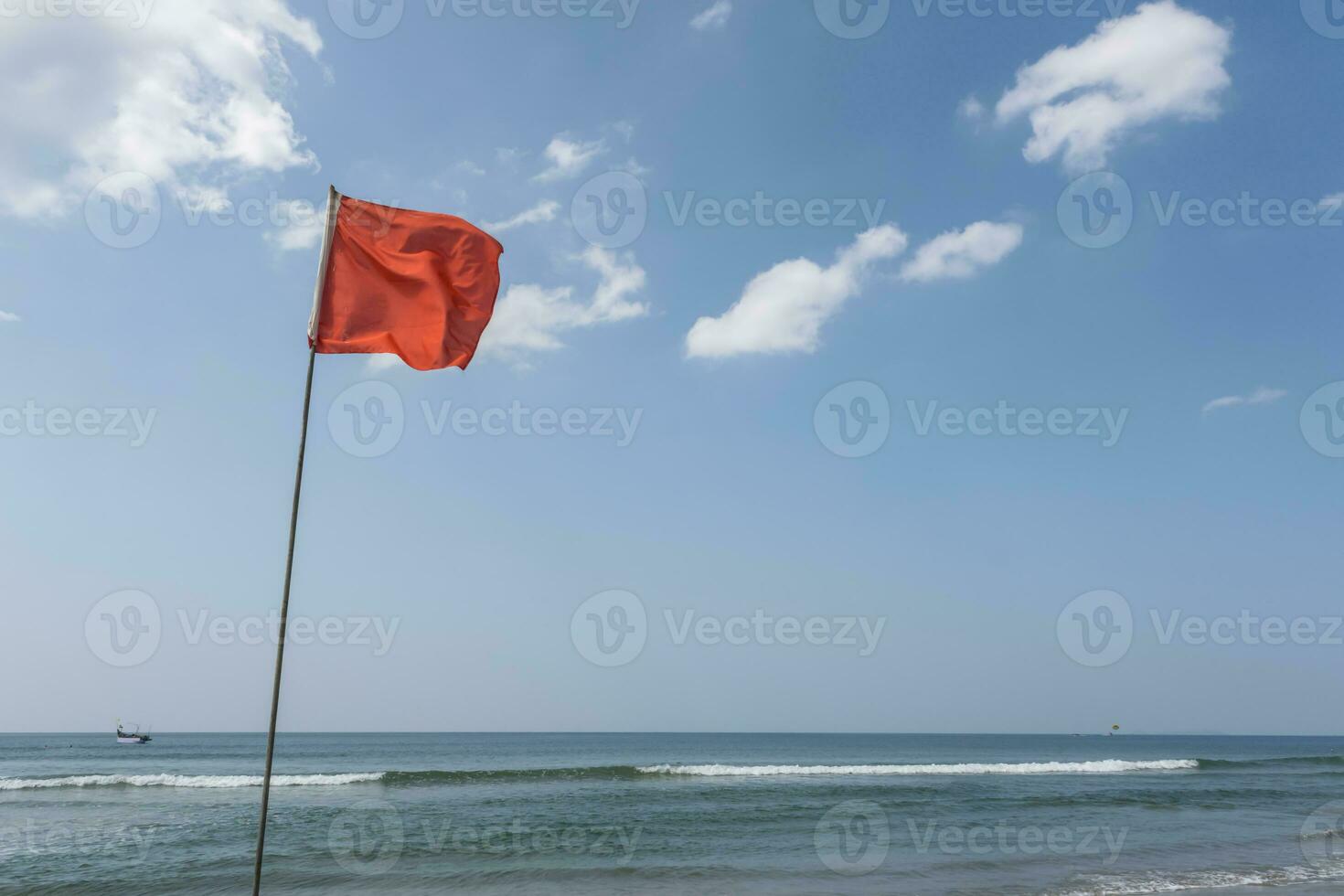 red flag on beach on sea or ocean as a symbol of danger. The sea state is considered dangerous and swimming is prohibited. photo