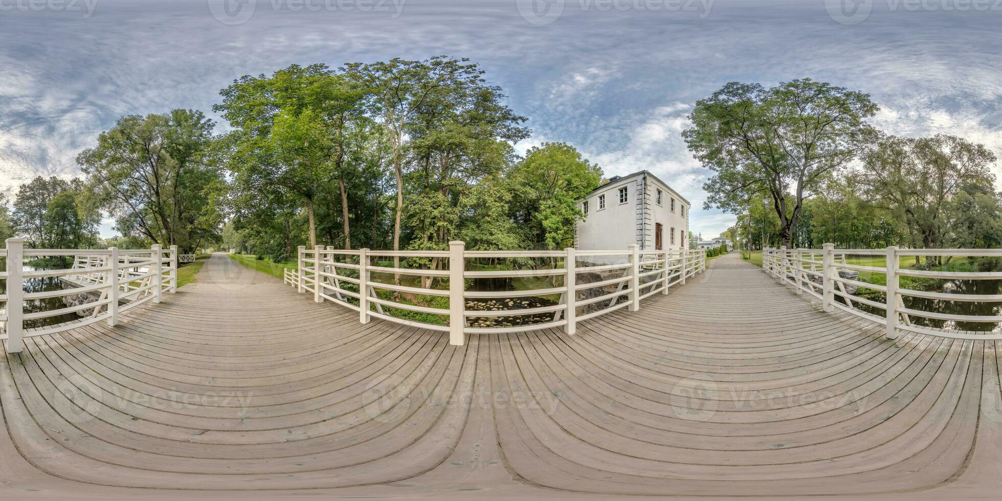 full seamless spherical hdri 360 panorama view on wooden bridge over small river in forest in equirectangular projection, VR AR content. photo