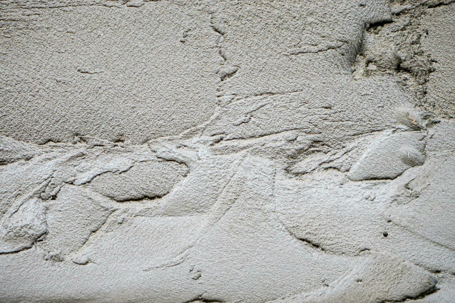 Closeup and crop texture of mortar and cement on building wall at construction site background. photo